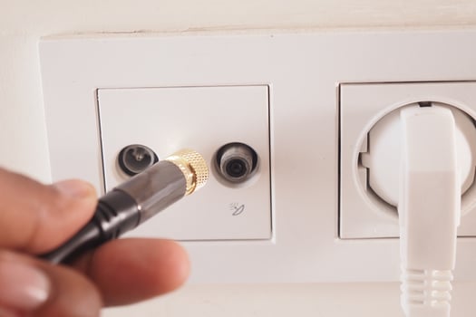 Connecting a cable to an electronic socket at home photo