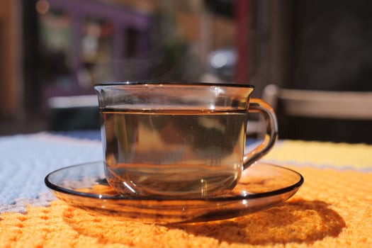 Warm cup of tea on a colorful table setting photo