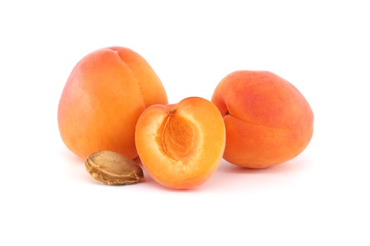 Fresh Whole and Half Apricots on a White Background photo
