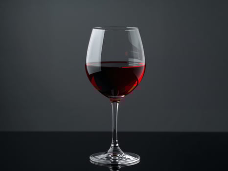 Elegant Still Life. A Single Glass of Red Wine on a Reflective Black Surface. photo