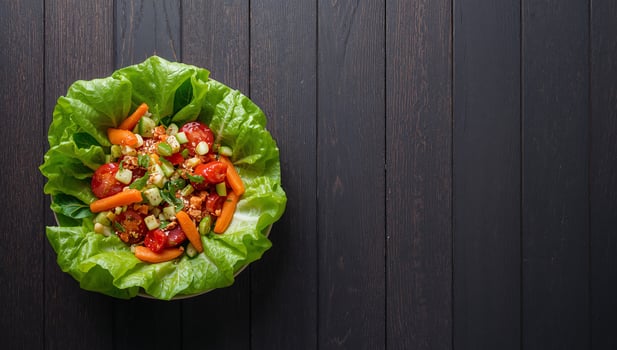 Fresh Vegetable Salad on Lettuce Bedding, with Tomatoes, Carrots, and Cucumbers. photo
