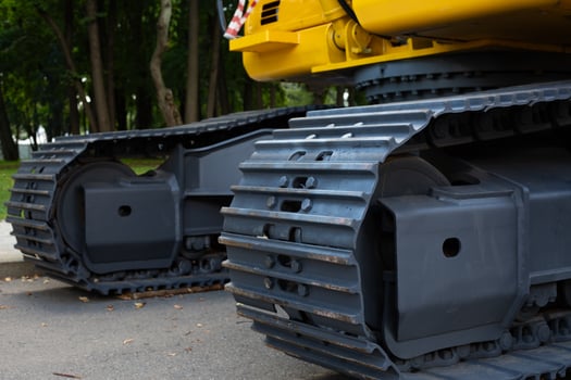 Close up photo of excavator track. Excavator on tracked mount for better balance and stability on the surface. Track of special transport for construction work