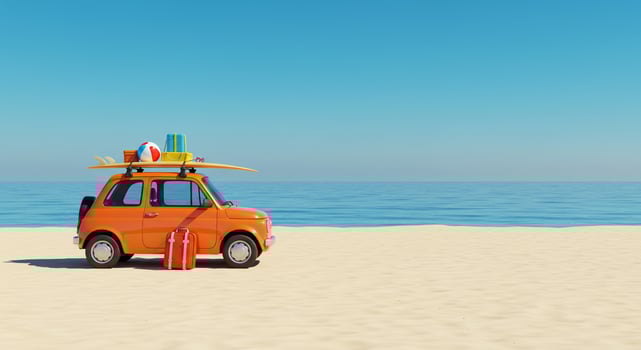 Orange Vintage Car with Surfboard and Luggage on Sandy Beach by the Ocean photo