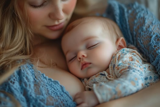 A woman holding a baby while laying on her chest photo