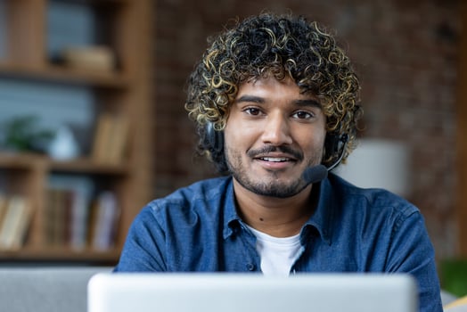 Man with headset at a laptop photo