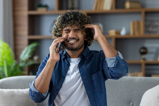 Frustrated man talking on phone photo