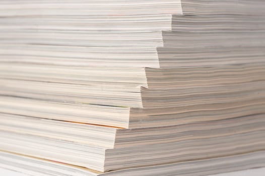 A stack of papers with the top one being the thinnest photo