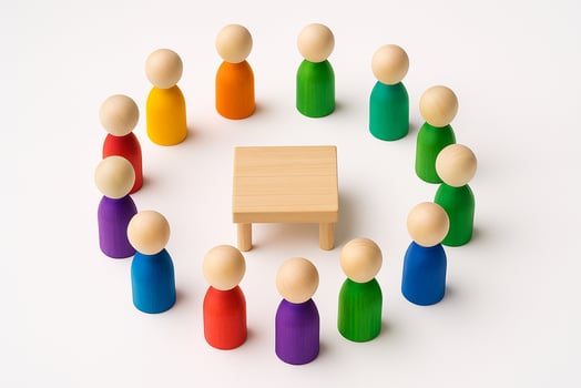 A circular arrangement of multicolored wooden peg figurines around a blank wooden banner symbolizing diversity, inclusion, and equity photo