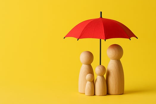 Three wooden family figurines under a red umbrella on yellow background representing security, insurance, and protection photo