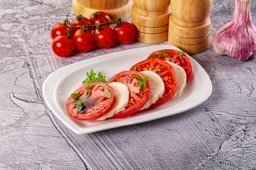 A plate with tomatoes and garlic on it photo