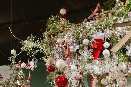A Christmas tree with a lot of decorations including a lot of bells photo