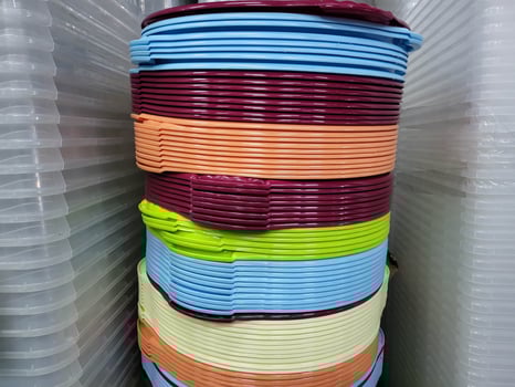 A stack of colorful plastic basins and containers in the store photo