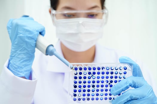 Scientist with cell culture in sample micro plate for research in science laboratory. photo