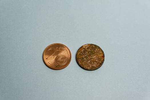 Two euro cent coins on white background one new and one aged photo