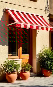 A red and white awning is on the front of a building photo
