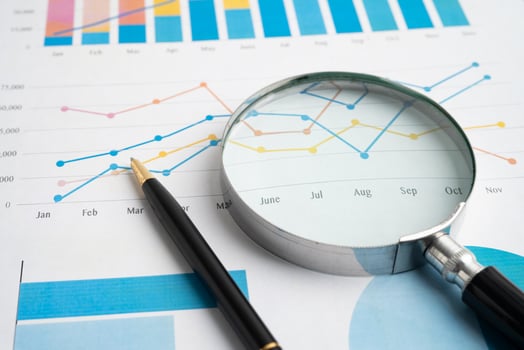 Magnifying glass business graphs and pen. photo