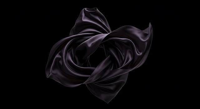 Elegant Black Satin Fabric Folded in Artistic Composition on Dark Background photo