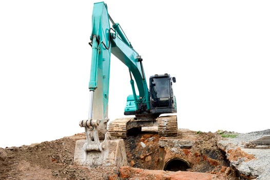 A large excavator is working in a workplace, isolated on a white background. photo