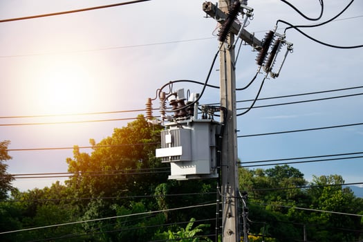 Large electric transformers installed on electric poles photo