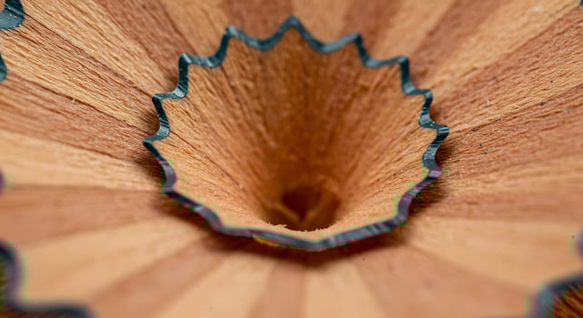 Close Up of Pencil Sharpener Hole in Wooden Pencil with Metal Blade photo