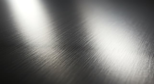 Close-up of Metallic Surface with Textured Brushed Finish in Silver Tone photo