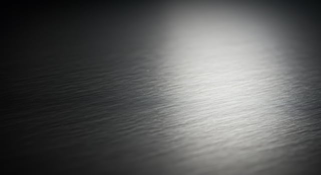 Close Up of Textured Metallic Surface with Reflections in Silver Tones photo