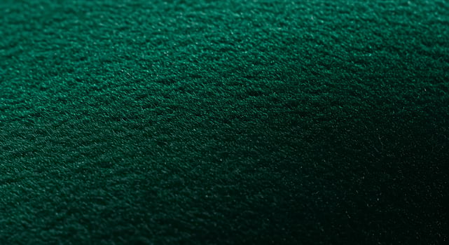 Closeup of Green Velvet Fabric Showing Textured Surface in Soft Lighting for Textile and Interior Design Use photo