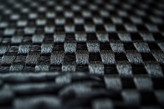 Detailed weaving texture in black displays an abstract pattern formed across a dark surface photo