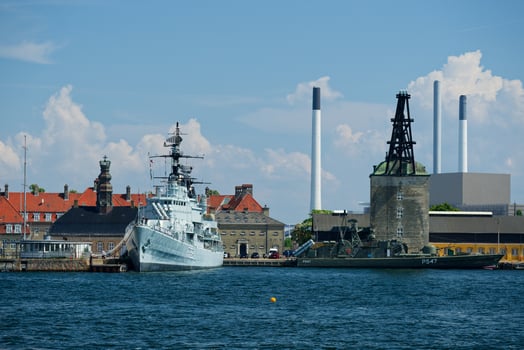 Harbor Scene with White Passenger Ship and Dark Green Military Vessel in Copenhagen CPH photo