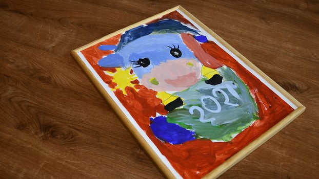 Kids painting of cow character as symbol 2021 for Chinese New Year by oriental tradition photo