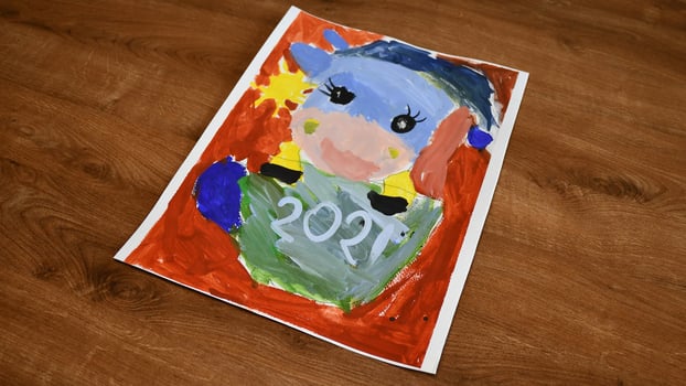 Colorful childpainting of cow character as symbol 2021 for Chinese New Year by oriental tradition photo