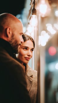 Romantic couple on date night with warm bokeh lights background. Man and woman enjoying intimate evening together. Love, relationship and romance concept in cozy atmosphere. photo