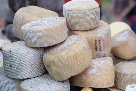 Craft cheese for sale at a farmer's market. Industry photo