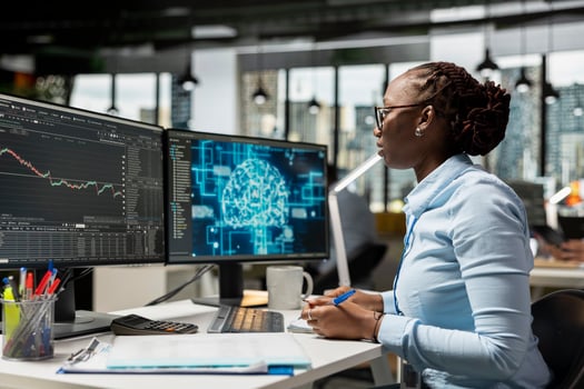 Proprietary firm expert in office using machine learning models to enhance predictive accuracy of stock market movements. Trader leveraging AI to optimize trading strategies and reduce manual workload photo