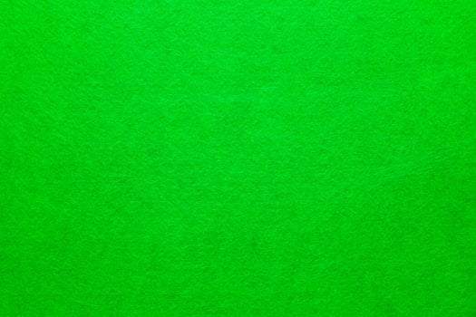 Bright green textured fabric background used for creative projects and displays photo