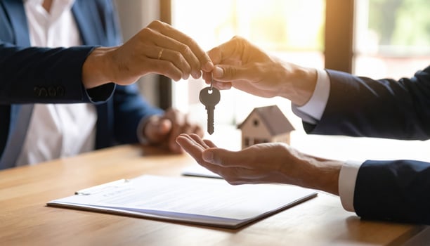 Person handing over key symbolizes transfer of property ownership, highlighting trust and new beginnings in real estate transactions. scene conveys professionalism and excitement photo