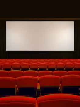 A row of neatly arranged red movie seats in an empty movie theater. Film industry. photo