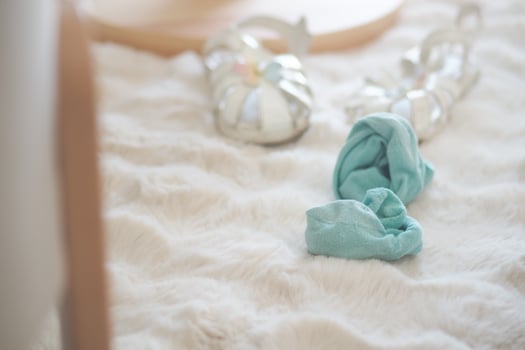 Colorful hair scrunchie and silver accessories on rug photo