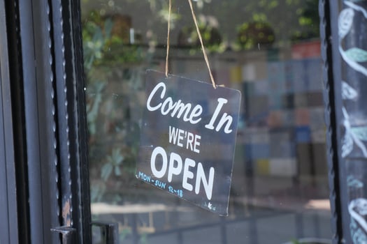 Open sign welcomes customers to local business photo