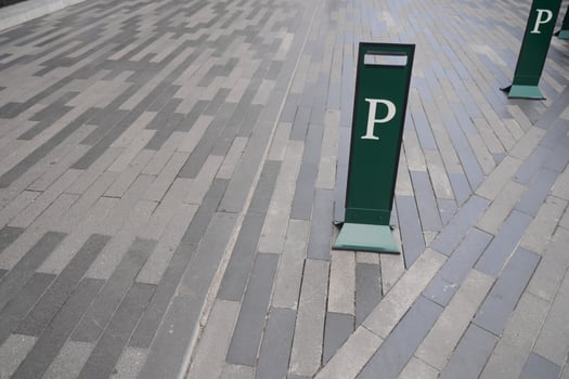 Parking signs along a modern paved walkway photo