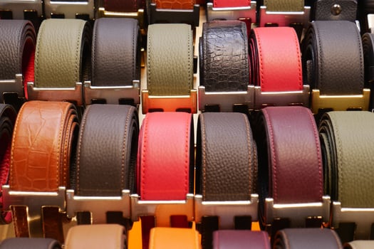Colorful display of belts arranged for retail sale photo