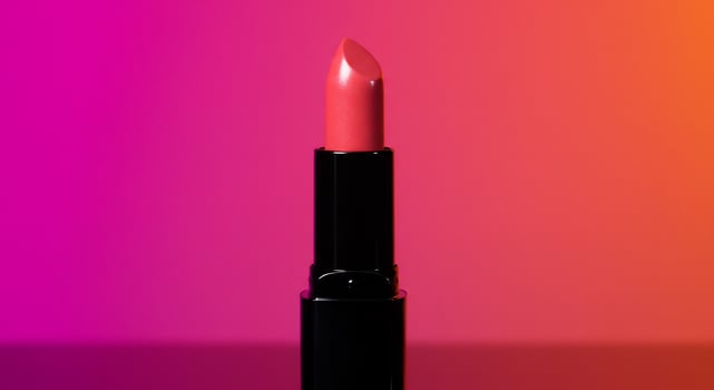 Radiant Coral Lipstick on a Bold Magenta and Orange Gradient photo