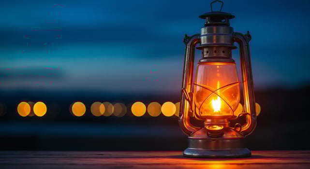 Vintage Lantern's Golden Flame Against a Cool Blue Twilight Bokeh photo