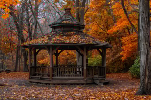 Wooden gazebo standing in colorful autumn forest photo