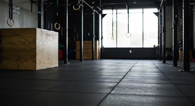 A gym with a black floor and wooden boxes photo