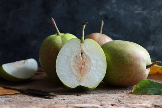 Fresh pear fruit on rustic background. photo