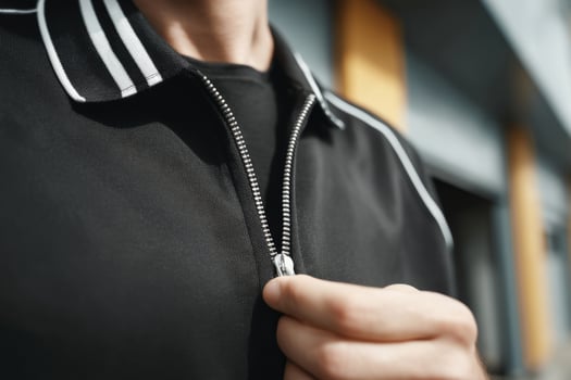Close up of a man adjusting his zipper photo