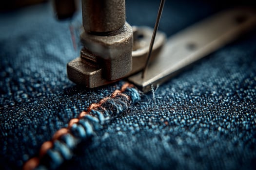 A close up of a sewing machine with a thread photo