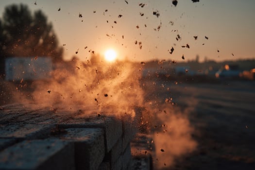 A brick wall with dust and sand falling photo