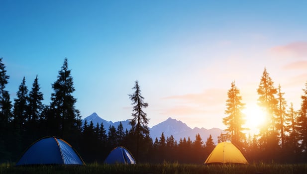 Scenic camping tents at sunset in nature landscape photo